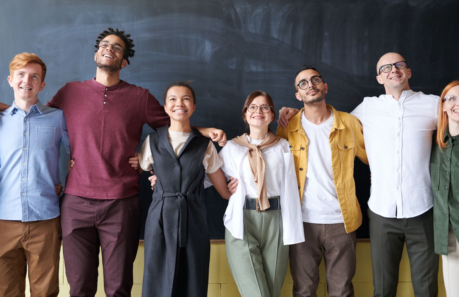A diverse community joining hands together