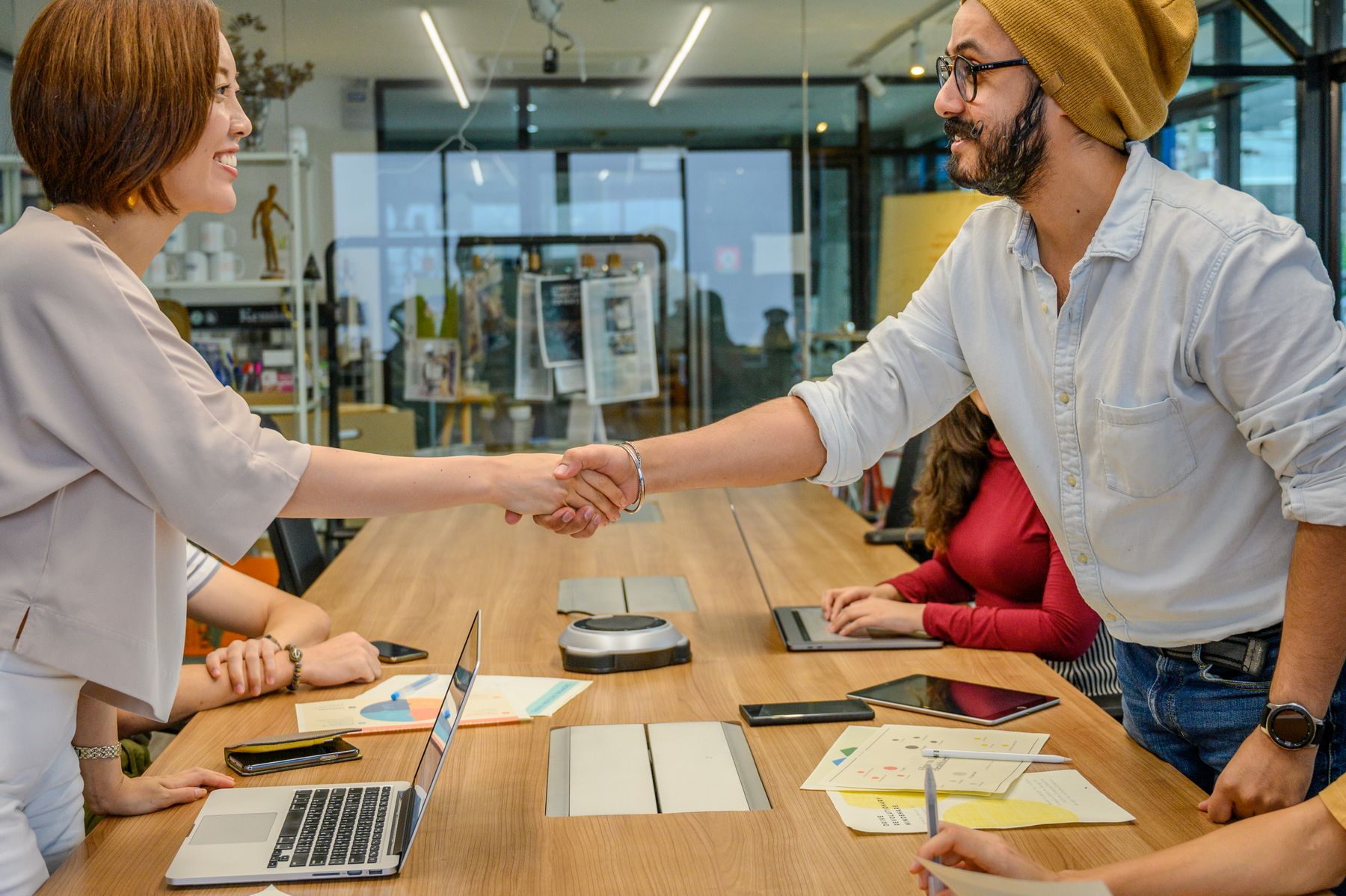 A diverse team forming a partnership during a collaborative meeting