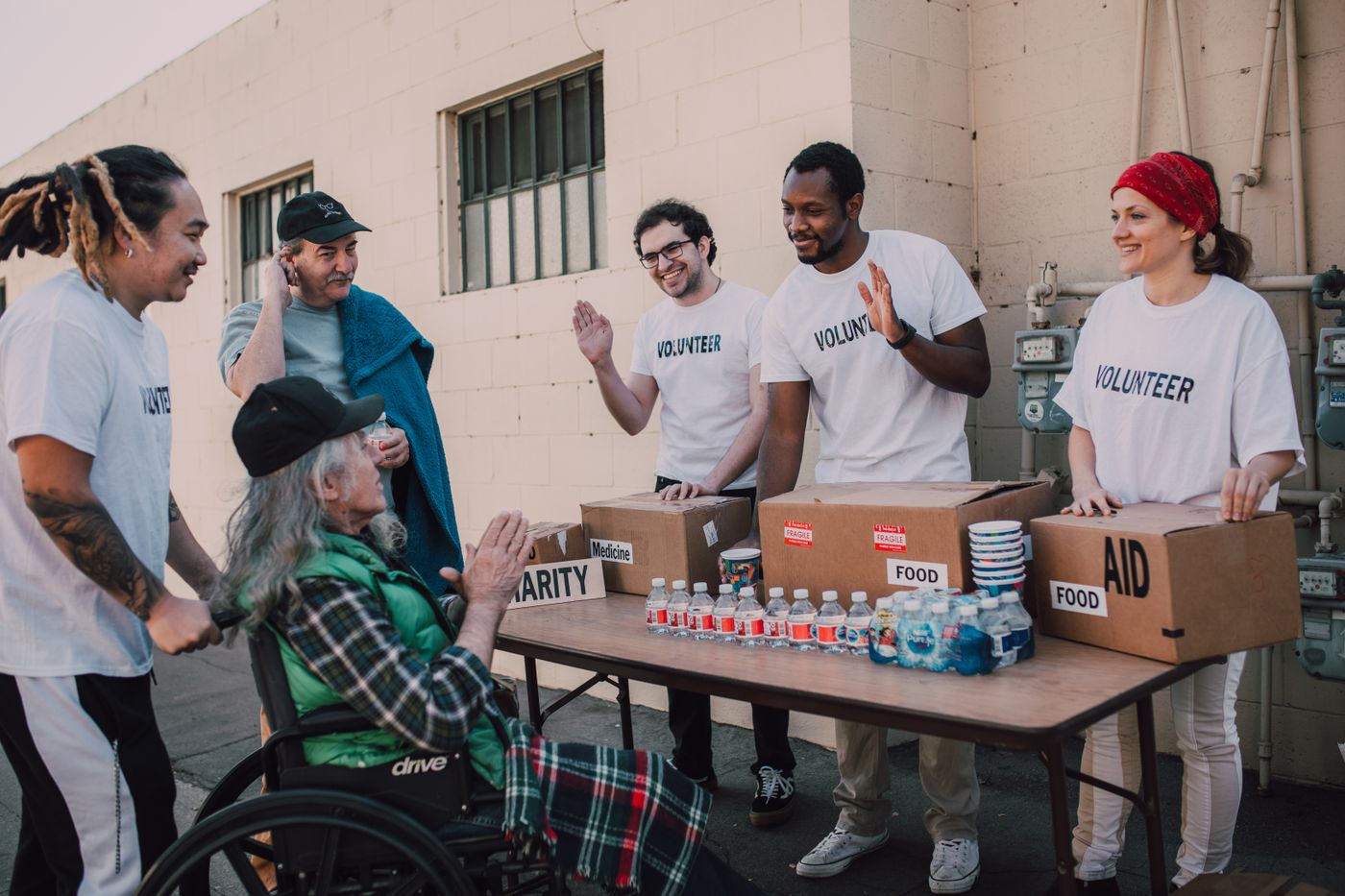 Volunteers supporting a person during a community outreach event